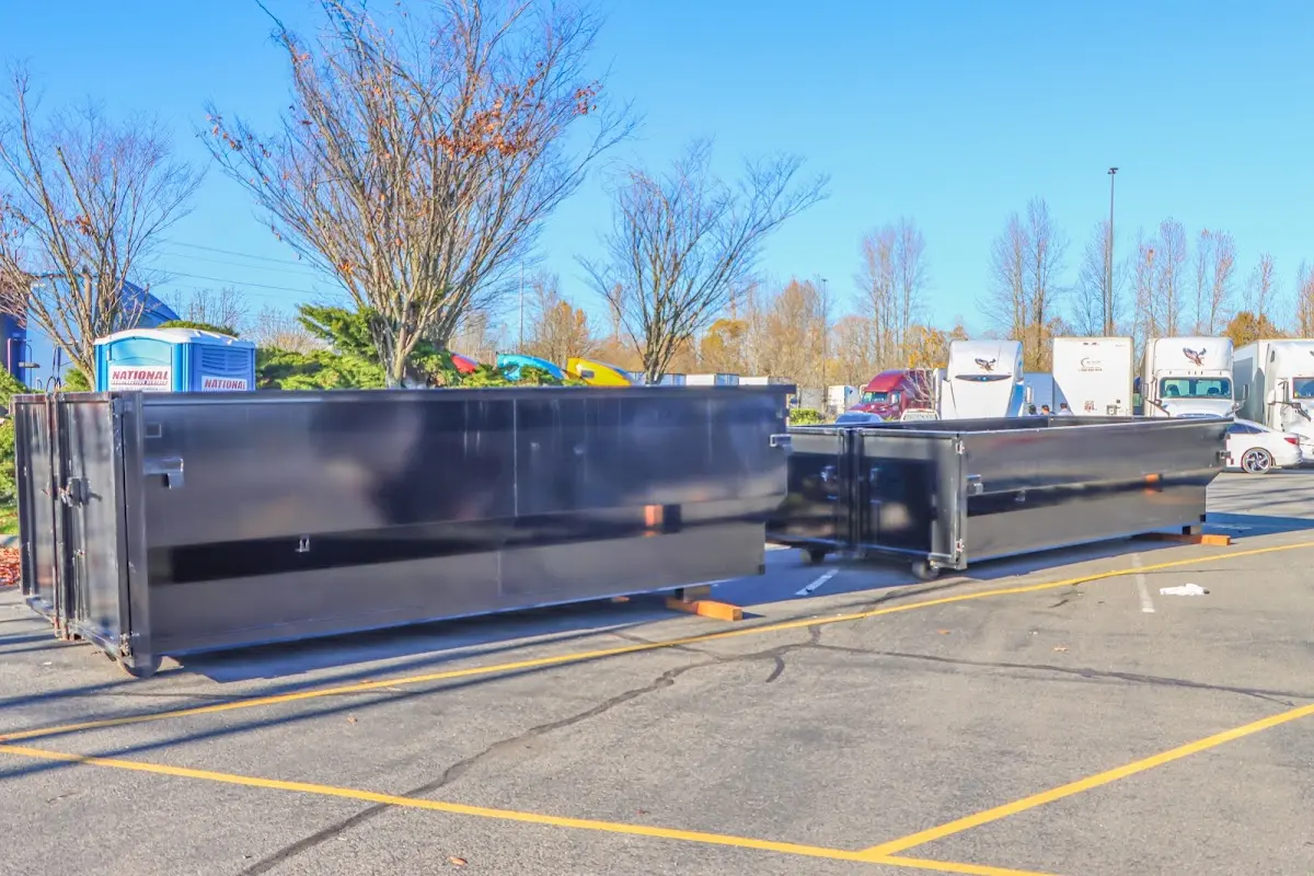 Professional dumpster rental service with roll-off container on residential driveway in Pembroke Park